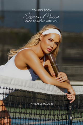 Isabel Alysa in white dress on pickleball court leaning over net holding New Dolce Glow express mousse.