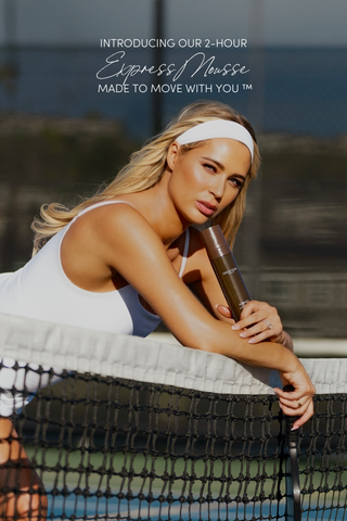 Isabel Alysa in white dress on pickleball court leaning over net holding New Dolce Glow express mousse- made to move with you.