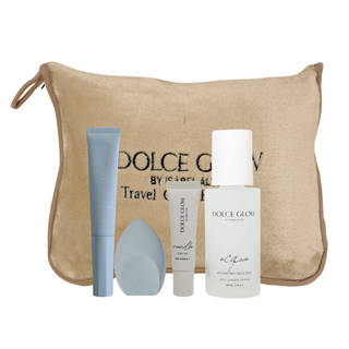 Dolce Glow travel bundle includes Acqua face mist. self tanning contour, vanilla lip butter and blending sponge. Canon camera, passport, and earbuds also in image on a blue background.