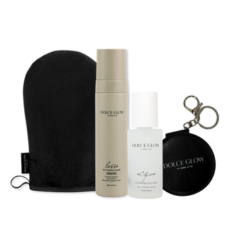 Dolce Glow Travel bundle on bathroom counter including a Lusso mousse, Acqua tanning water, application mitt hair clip and mirror.